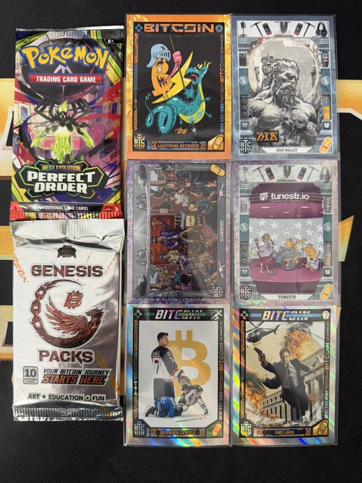 A collection of trading card packs displayed on a dark surface, including a 'Pokémon Trading Card Game Perfect Order' pack, several 'Bitcoin' themed card packs (Tuttle Twins, Zeus Wallet, Tunestr), and a 'Genesis Packs' pack referencing 'Your Bitcoin Journey Starts Here'.