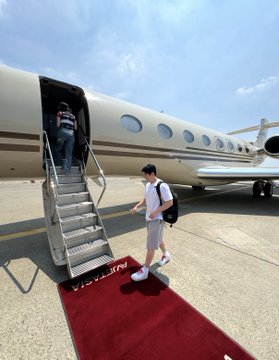 The image shows a person boarding a private jet, likely a Gulfstream, on a red carpet. This aligns with the "Zama Holder Life" post, suggesting a luxurious and exclusive travel experience.