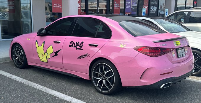 A pink Mercedes-Benz sedan sits in a dealership lot, wrapped in "SWAG" branding and a Pikachu graphic with "Grass Type" decals, displaying a "Kills Bugs Dead" sticker on the rear window—pairing perfectly with the post's "when I finally make it" sentiment by showcasing a flashy, personalized ride as a future flex of success.