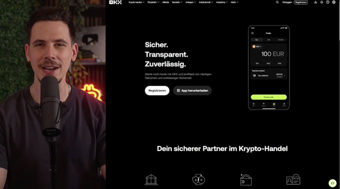 A screenshot of a video showing a man speaking into a microphone next to the OKX cryptocurrency website, featuring German text like 'Sicher. Transparent. Zuverläss.'