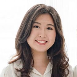 The image shows a smiling young woman with long dark hair, presumably Joyce Kim, the author referenced in the post about Stellar Lumens (XLM). She appears professionally dressed in a light-colored top, suggesting a corporate or executive headshot style that aligns with her role as a co-founder of Stellar Development Foundation.