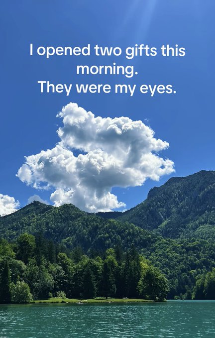The image features a beautiful mountain landscape with a large body of water below. The caption reads "I opened two gifts this morning. They were my eyes." This quote seems to be related to the content of the image, as if the mountain and water symbolize the gifts that have been given or experienced in life. The post is about staying consistent and engaged in daily activities, just like how the water flows with the ecosystem around it. The caption also mentions GM friends, which could indicate a social aspect to this quote or simply be an inside joke between the poster and their followers.