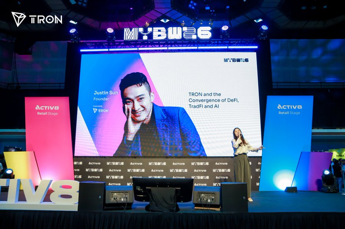 A conference stage at MBW 2025 (likely Money20/20 or similar) featuring a large screen showing Justin Sun, Founder of TRON, with the topic 'TRON and the Convergence of DeFi, TradFi and AI', presented on the Activ8 Retail Stage with TRON branding.