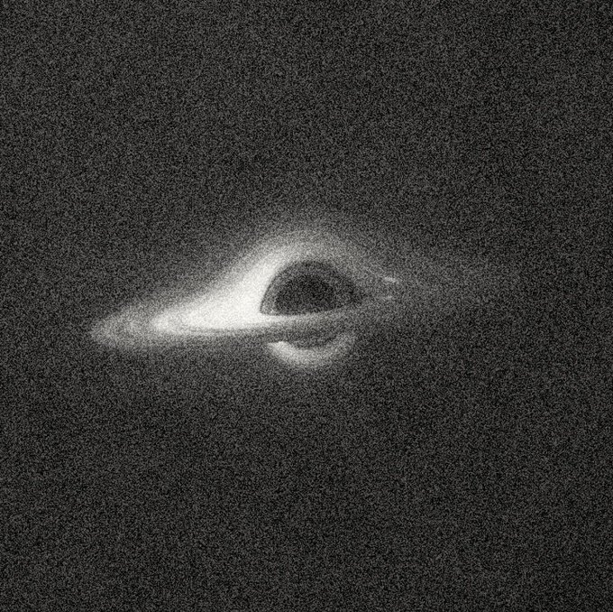 A grayscale astronomical image showing what appears to be a black hole or deep space phenomenon surrounded by swirling gas or dust.