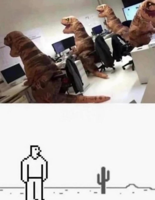 A meme image showing an office setting where three people sitting at desks are wearing inflatable T-Rex costumes, contrasted with a simple pixel art image below of a figure standing in a desert with a cactus.
