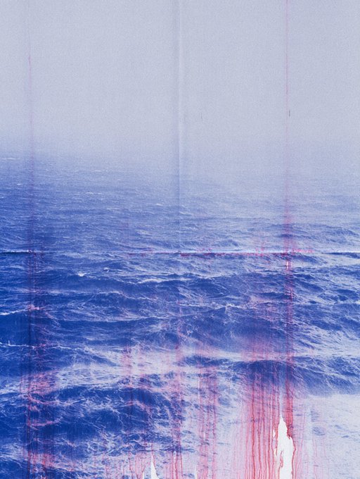 An artistic photograph of ocean waves with pink/red vertical streaks and drips overlaid on the image.