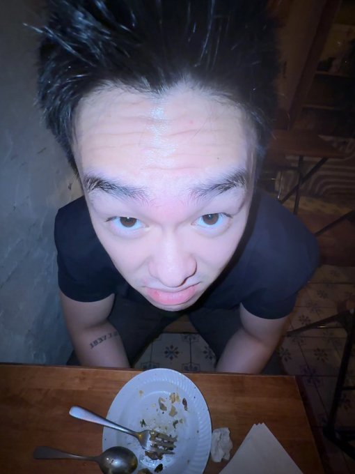 The image shows a man sitting at a table with food on his plate, including a piece of chicken that appears to be partially eaten. He has a spoon next to him on the table. The photo also contains text that reads "Successfully introduced a match 5BNB". This suggests that someone might have posted this picture online or shared it on social media, possibly as part of a celebration or event involving matches and food.