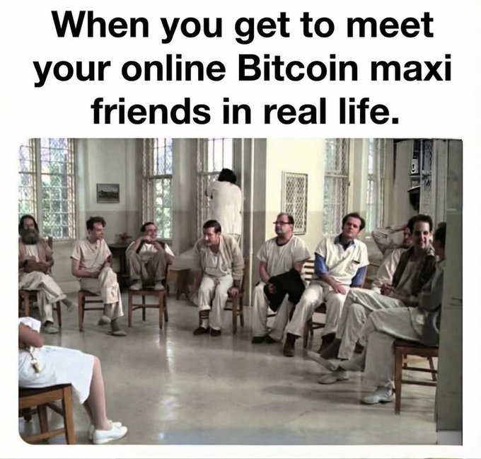 A meme with the text 'When you get to meet your online Bitcoin maxi friends in real life.' shows a scene of several men in white straightjackets sitting in a circle in what appears to be an asylum.