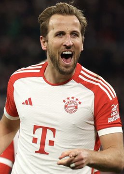 A bearded football player in a red and white FC Bayern Munich jersey with the "T" sponsor logo shouts in celebration, appearing to celebrate a goal or victory. The image relates to the post about a large bet placed against Bodø/Glimt winning against Bayern Munich, suggesting confidence in the star-studded German club's dominance.
