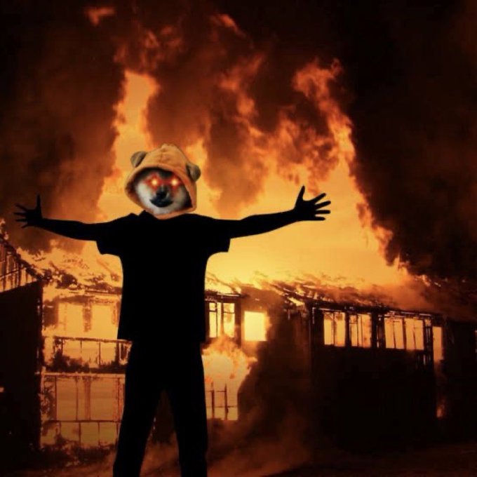 A dramatic scene of a person wearing a bear mask with glowing red eyes, arms outstretched, silhouetted against a massive fire engulfing a building.