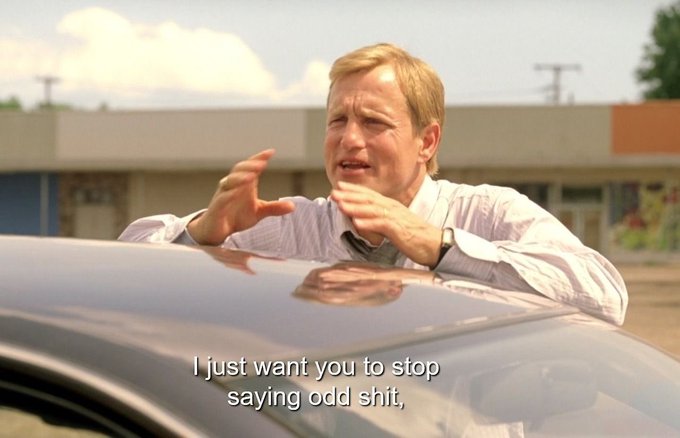 A blonde man in a white dress shirt and tie leans over the hood of a car, gesturing with both hands while speaking. The caption reads "I just want you to stop saying odd shit," — a meme used to humorously caption awkward or off-brand company communications being discussed in Slack.