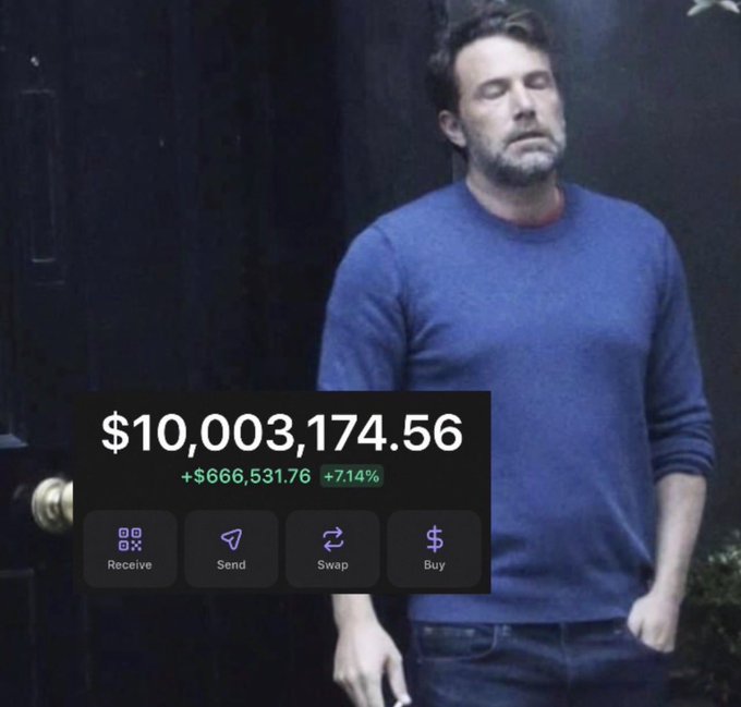 A man in a blue sweater stands with his eyes closed in a meme showing a crypto wallet balance of $10,003,174.56, up $666,531.76 (7.14%), with options to Receive, Send, Swap, or Buy.