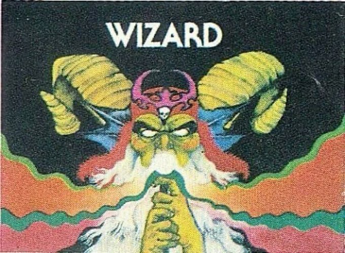 A vintage-style illustration with the text 'WIZARD' at the top, depicting a fantasy character with large yellow ram-like horns, a menacing green face, and colorful flowing robes in a psychedelic art style.