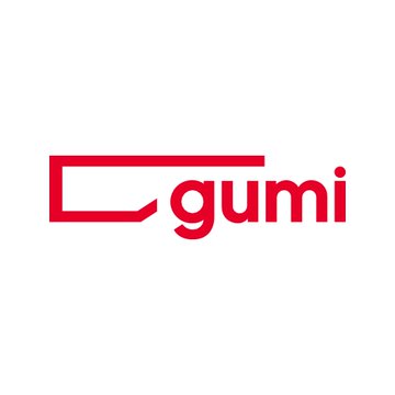 The image displays the red "gumi" logo of the Japanese game developer. It relates to the news that Gumi is launching an $18.3M Bitcoin and altcoin investment fund in partnership with SBI Financial Services, backed by investors including Daiwa Securities Group.