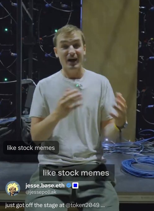 A man in a gray t-shirt speaking on stage, with tweet caption from @jessepollak "just got off the stage @token2049" and overlay text "like stock memes".