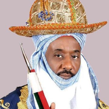 The image shows an individual in traditional regalia, identified by the caption and text as #SUNUSI, who is being compared to "Sarkin Crypto $SUNUSI" in a post about crypto trading.