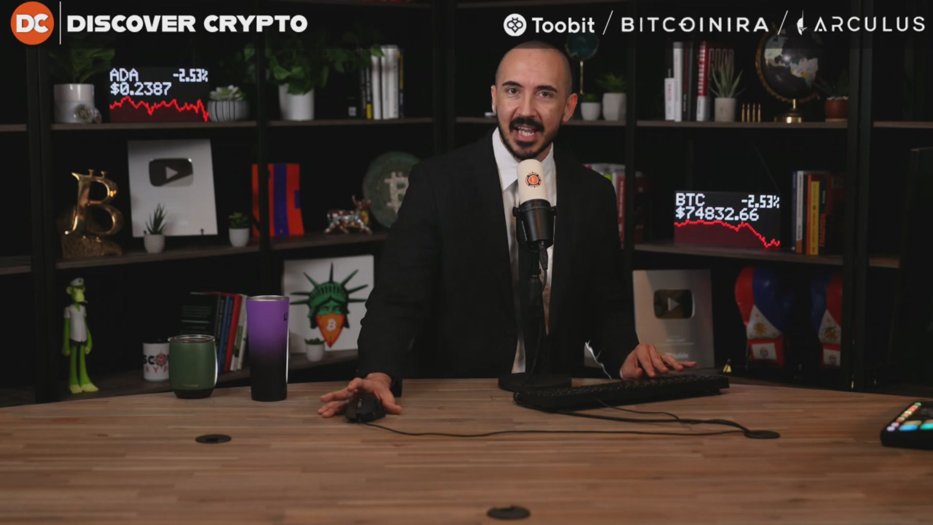 The image shows a man sitting at a desk with a computer, possibly working or giving a presentation. There are several books surrounding him, indicating that he might be researching or studying something related to cryptocurrency. The caption of the image reads "Is Ethereum Dead? (Time To Sell?)". This suggests that there is some discussion about the future of Ethereum and its potential impact on Bitcoin's value.