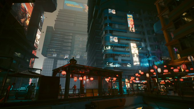 A cyberpunk-style cityscape at night featuring towering skyscrapers covered in illuminated billboards, with a walkway adorned with glowing red paper lanterns below.