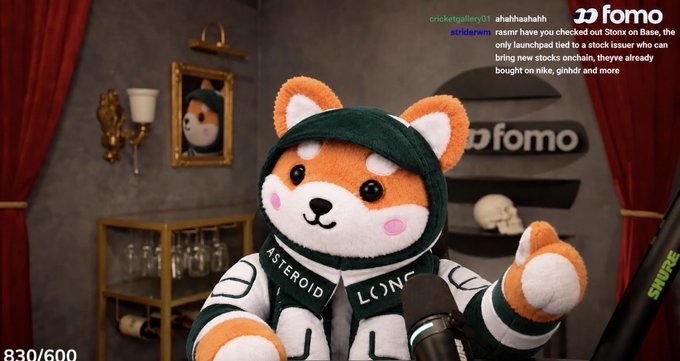 A streamer using a Shiba Inu dog avatar wearing a green hoodie with 'ASTEROID' text, broadcasting for 'fomo' with visible Twitch chat including comments about checking out 'Store on Base' and various stock tickers.