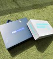 Small thumbnail showing two product boxes, one dark blue and one white with light blue graphics, sitting on grass.