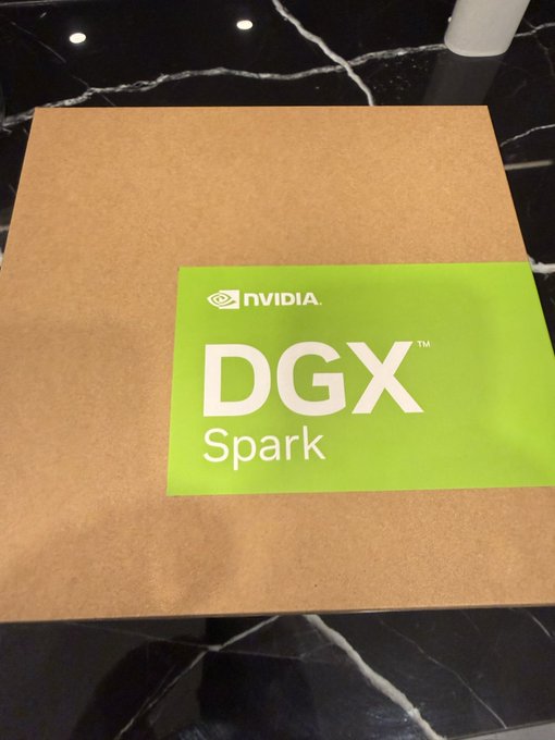 A brown cardboard box sitting on a black marble surface, bearing a bright green sticker with the NVIDIA logo and the text 'DGX Spark'.