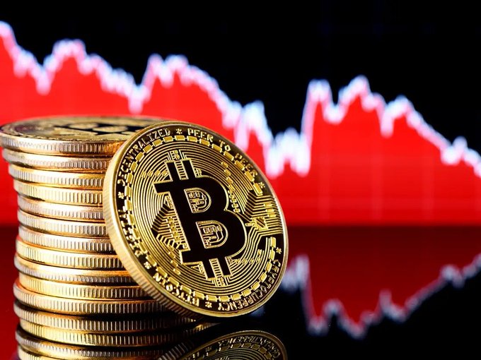 The image depicts a stack of Bitcoin coins, with one particular coin worth 50 Bitcoins displayed prominently at its center. A red bar graph shows Bitcoin prices going through the 70 thousand dollar levels, indicating a steep decline in value over the past six months. The Bitcoin price drops by 4% to its lowest levels since April, making it reach the lowest point in terms of value seen on cryptocurrency exchanges. It is worth examining how this market performed during that time and analyzing potential factors contributing to these fluctuations.