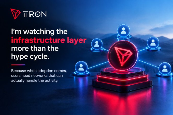 A Tron (TRON) promotional graphic with red neon lighting, showing the TRON logo and user icons connected in a network, with text 'I'm watching the infrastructure layer more than the hype cycle. Because when adoption comes, users need networks that can actually handle the activity.'
