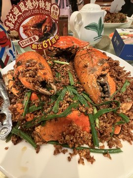 The image showcases a large, mouth-watering crab dish, prominently labeled with "Fatty Crab Singapore Chili Crab Set," featuring a price tag of "$61.20." This luxurious meal aligns with the post's description of an expensive and delicious dinner experience, highlighting the crab as a centerpiece of the gathering.
