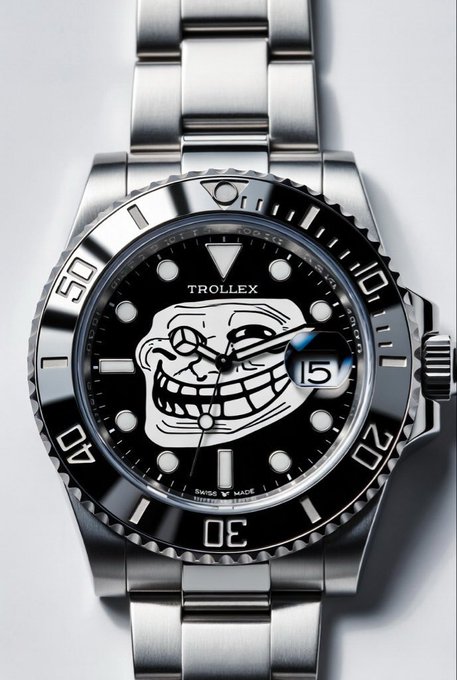 A close-up photograph of a stainless steel wristwatch labeled 'TROLLEX' featuring a black dial with a troll face meme illustration, a date window, and a unidirectional rotating bezel.