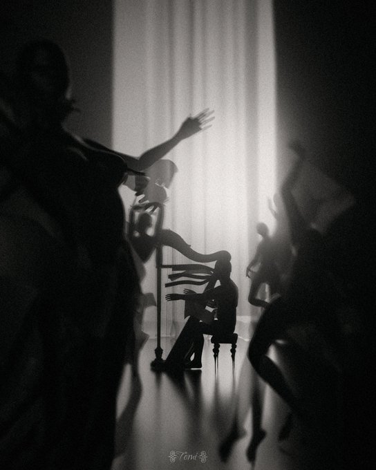 A surreal black-and-white silhouette artwork showing a musician playing a piano while ethereal figures dance around them, signed 'Toni' at the bottom.