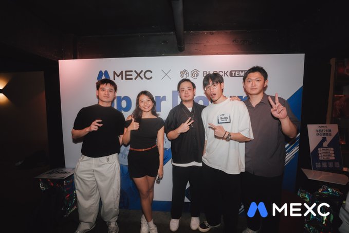 Five attendees pose at a MEXC × BlockTem co-branded event backdrop, flashing hand signs and thumbs-ups, matching the post's upbeat "#MEXCEventRocks" vibe with the visible "MEXC" and "BLOCKTEM" logos and the MEXC watermark.