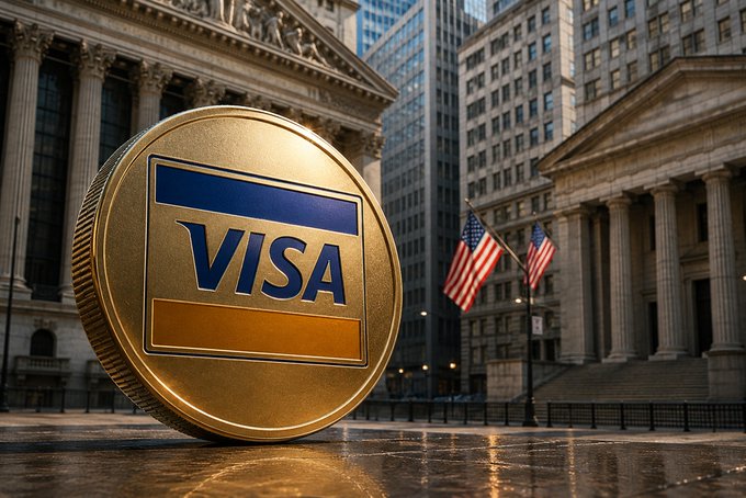 A large gold Visa coin sits in front of a classical building with columns, with two American flags and city skyscrapers in the background.
