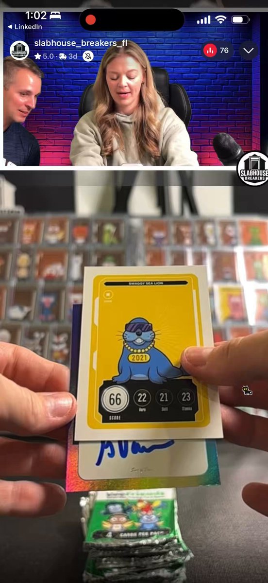 In the image, a person's hand is holding a card with a cartoon character on it, which appears to be a rare robot. The person is showing off the card against a backdrop of two other cards - one green and one blue. The text in the image reads "The Queen of @veefriends TCG and @slabhouse_slogo @garyvee is this good?".