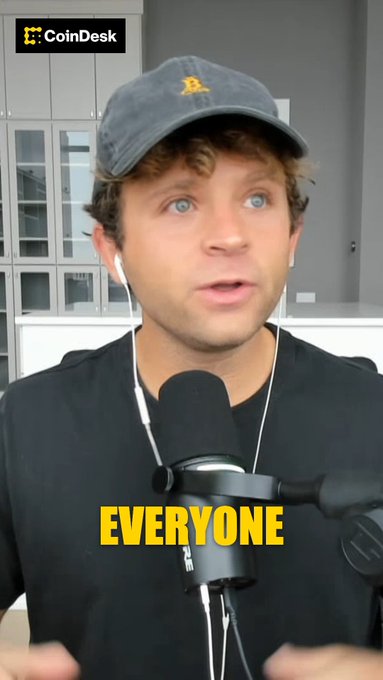 Jack Mallers, wearing a cap and speaking into a microphone on a CoinDesk segment with the caption "EVERYONE," advocates for Bitcoin as the premier hard asset choice amid fiat currency's declining purchasing power.