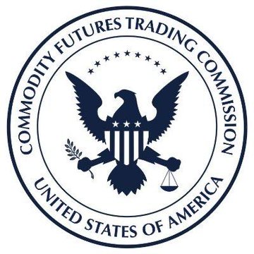 The official seal of the U.S. Commodity Futures Trading Commission (CFTC) is shown in dark navy blue, featuring an eagle with scales of justice and an olive branch, encircled by the text "COMMODITY FUTURES TRADING COMMISSION" and "UNITED STATES OF AMERICA." The image relates to the post as it represents the federal agency referenced in the announcement about CFTC's first round of proposed crypto market regulations.
