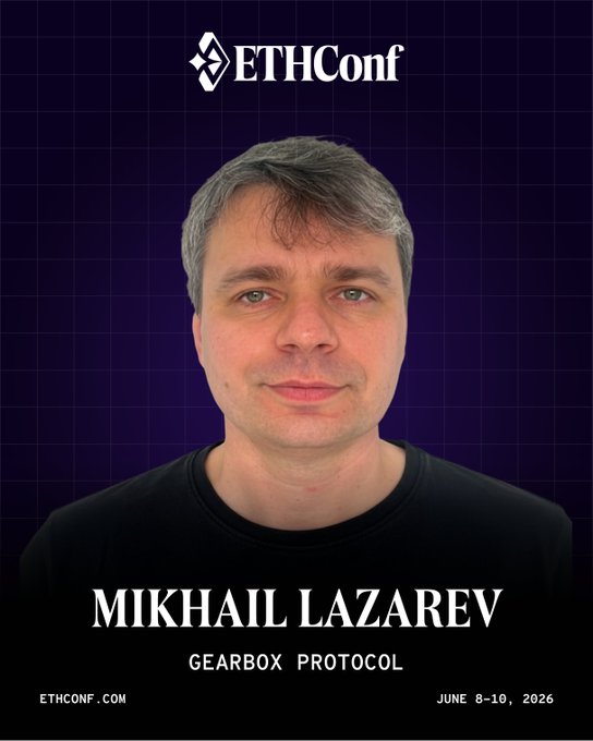 The image features a man wearing a black shirt who appears to be a speaker at an EthConf event. The text "Mikhail Lazarev" is written above his head, indicating that he is the main speaker for this particular conference. The background of the image is dark blue with white squares, and there are two other texts in the image: one reading "ETHConf" and another saying "June 8-10, NYC." This suggests that the event takes place at a convention center in New York City during the summer months of June.
