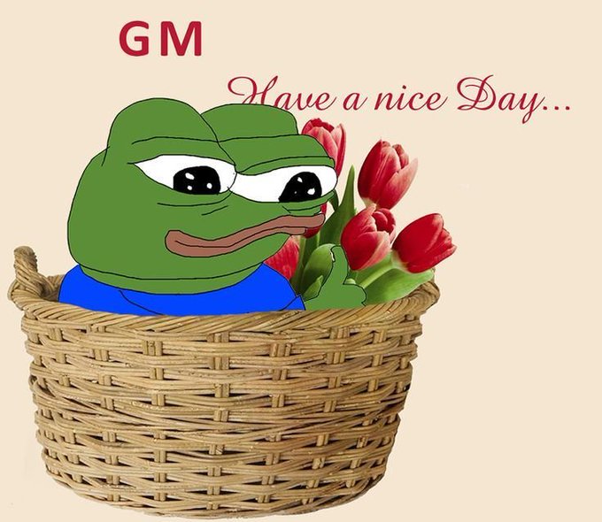 A cartoon Pepe the Frog sits in a wicker basket holding red tulips, with "GM" and "Have a nice Day..." written in red script above, matching the cheerful "good morning" greeting theme of the post.