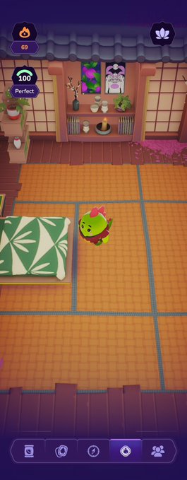 A screenshot of a mobile game featuring a green cactus-like character with a pink bow standing on an orange tiled floor in a cozy room with a "Perfect" score badge showing "100" and a currency counter at "69." The post mentions ongoing projects and references the @quipnetwork and quantum computing, but the image itself simply displays a gameplay moment without any direct connection to those topics.