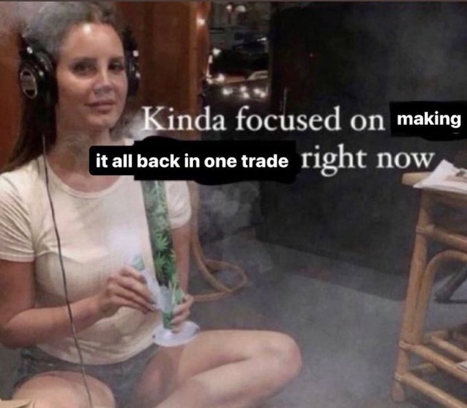 A meme featuring a woman wearing headphones and holding a bong, overlaid with text reading "Kinda focused on making it all back in one trade right now."