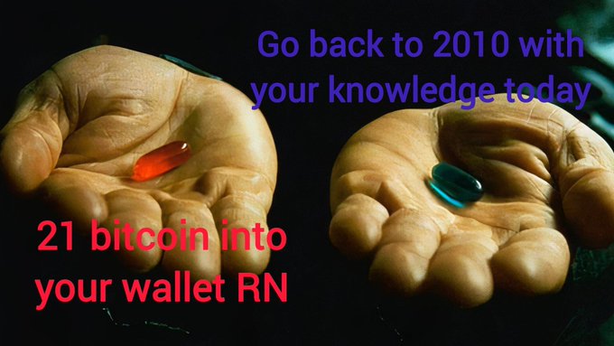 The image shows a person's hand holding two pills, one red and one blue. Below the image, there is text that reads "Go back to 2010 with your knowledge today". The text also includes numbers 21 and RN, which could be related to Bitcoin or an alternative currency.