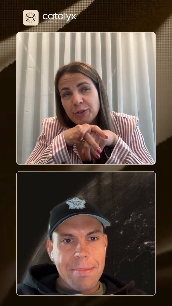 The image shows two people having a video call, with one person wearing a black hat and the other wearing a pink shirt. The background of the image has a patterned design that appears to be a dark brown color. There are also some text elements in the image, including "catalystix" and "verified institutional credentials, DNS verification, continuous credential monitoring."