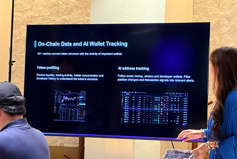 A presentation slide titled 'On-Chain Data and AI Wallet Tracking' is displayed on a large screen, featuring sections on token profiling and AI address tracking, with a presenter partially visible on the right.