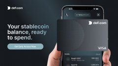 An advertisement for DeFi.com showing a phone displaying a crypto card with text reading 'Your stablecoin balance, ready to spend.'