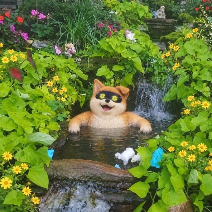 A happy Shiba Inu dog, the iconic mascot of the Dogecoin cryptocurrency, relaxes in a lush garden pond surrounded by yellow flowers. The image playfully connects to the post's reference to $AI (an AI-themed token), evoking the meme coin culture that originated with Dogecoin and now extends to newer tokens on platforms like Robinhood.