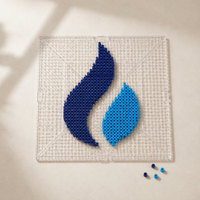 A photograph of a clear pegboard with two flame or water-drop shapes created from blue perler beads (one dark blue, one light blue) attached to it, with a few loose beads nearby.