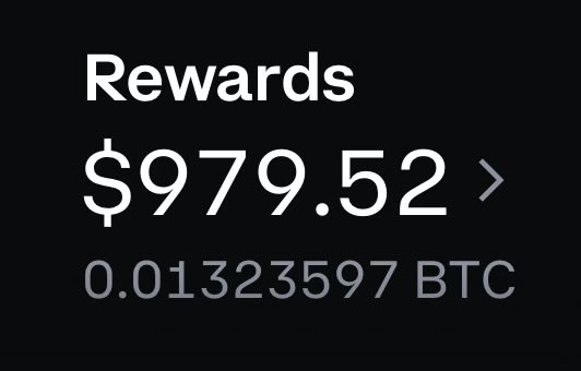 The image features a black background with white text, which reads "Rewards $99.57". The text is positioned above a number line, indicating a monetary value of $99.57. Below this information, there are two arrows pointing towards the numbers 0 and 1, suggesting that the rewards amount to either $99 or $99.57.