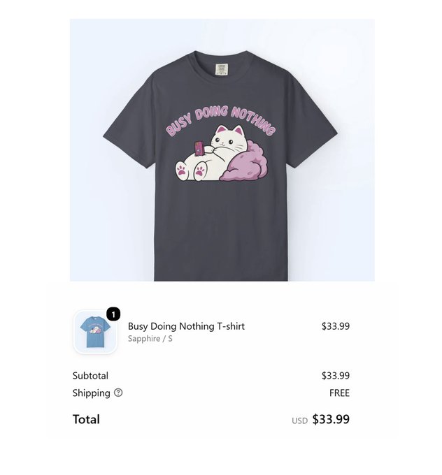 The image shows an online checkout page for a "Busy Doing Nothing T-shirt" in Sapphire size S from @sillykittiesco, priced at $33.99 with free shipping and USDC-enabled crypto payment integration.

The post highlights support for the brand by purchasing the cute cat-themed shirt as a gift, praising the founder's vision and the store's modern USDC payment integration while expressing hope for future mobile development.
