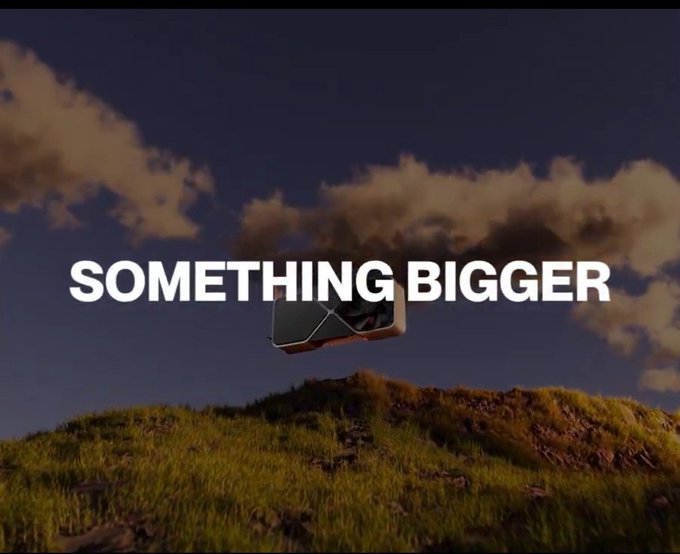 A dramatic landscape scene with the bold white text 'SOMETHING BIGGER' overlaid on a grassy hill under a cloudy sky, with a small box-like object floating mid-frame.