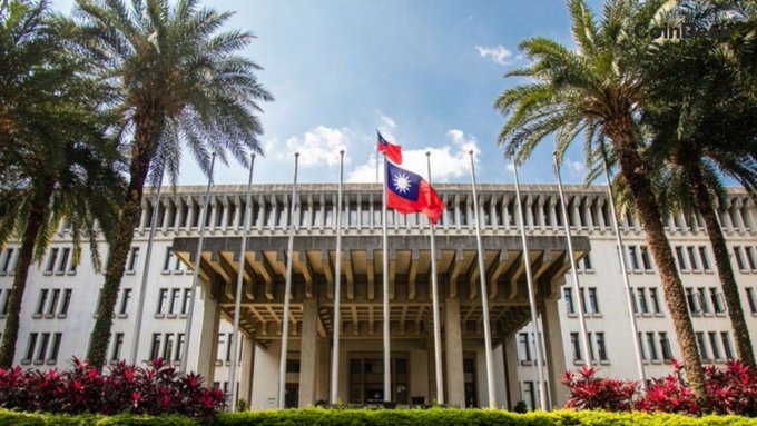 The image shows the exterior of a building flying the flags of Taiwan, likely representing a diplomatic or governmental building. The post’s context suggests this is in contrast to the US Congress's inability to pass legislation.