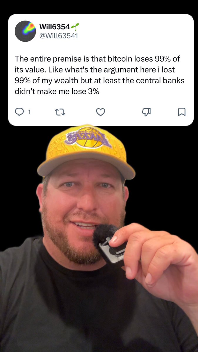 In the image, a man wearing a yellow hat is holding a cell phone with his right hand while looking at the camera. The background appears to be black, which contrasts with the bright colors of the man's hat. There are also some text elements in the image that include "WINS4G" and "WINS4G", possibly indicating an online platform or account related to Bitcoin trading or cryptocurrency news.